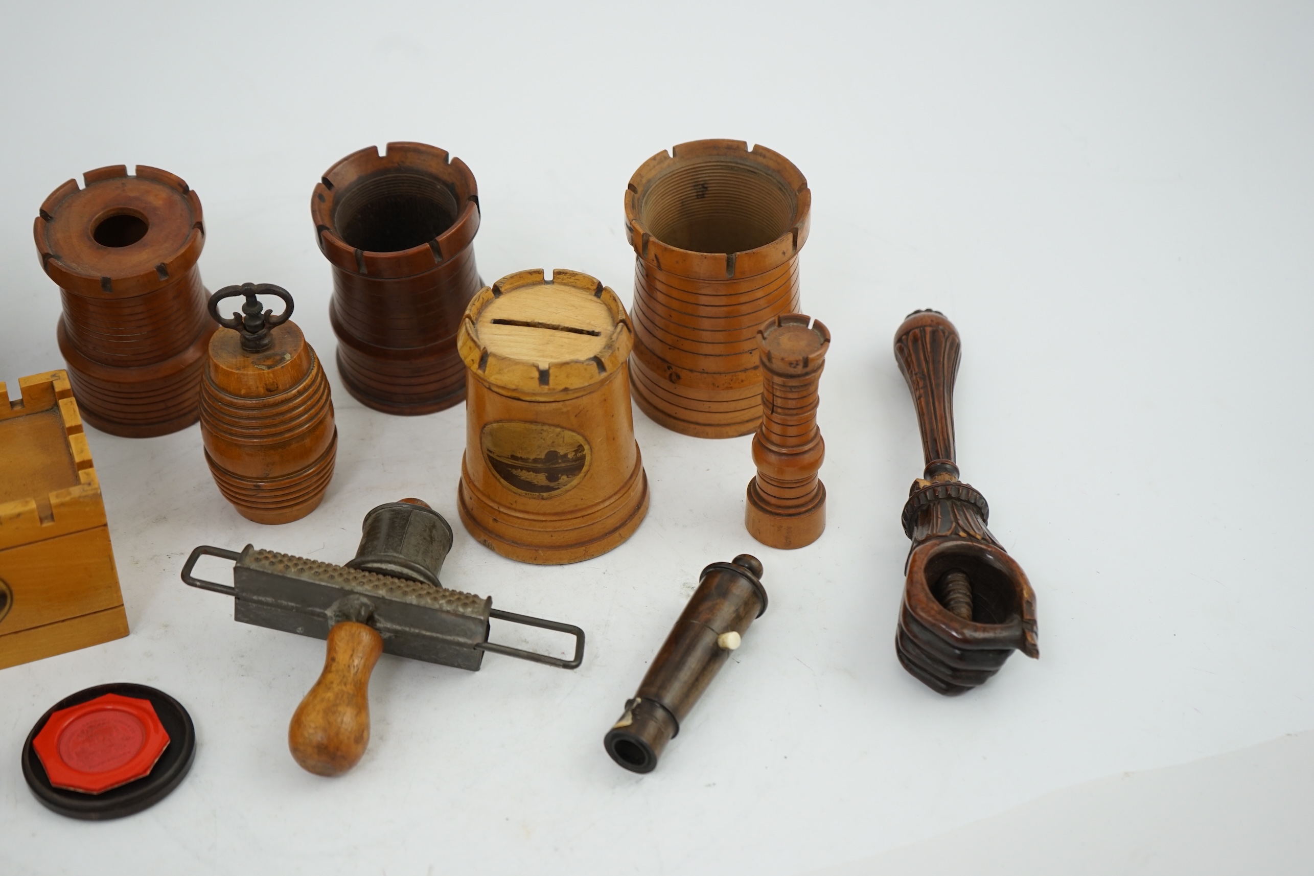 A collection of Victorian and Edwardian treen comprising castellated boxes, nutcrackers, kitchenalia and a glass holder. Condition - fair to good